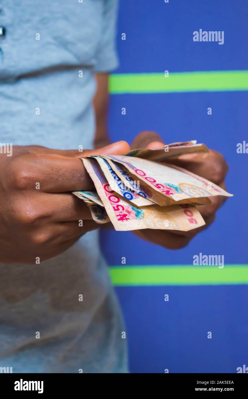 a young African Nigerian man counting his money Stock Photo