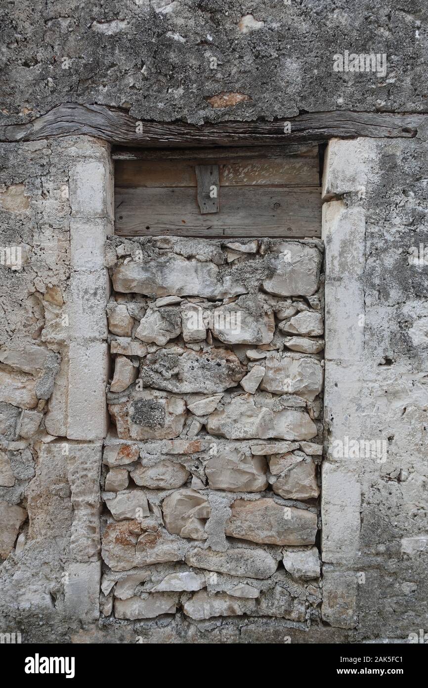 Spooky old house door frame sealed with rocks. Abandoned exterior Stock