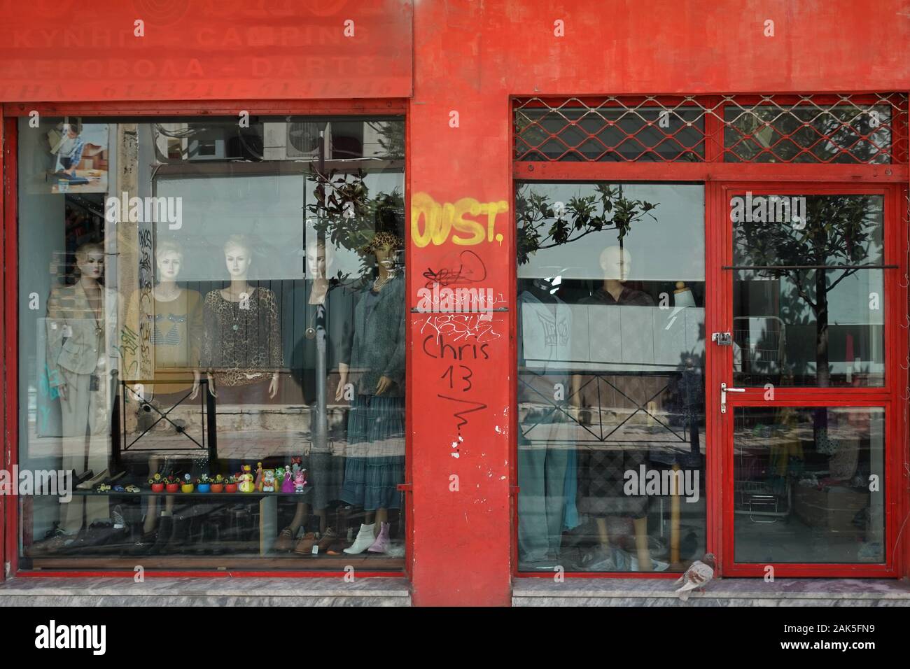 Athens, Greece - March 31, 2019: Small shop storefront window with clothing and goods imported from China. Stock Photo