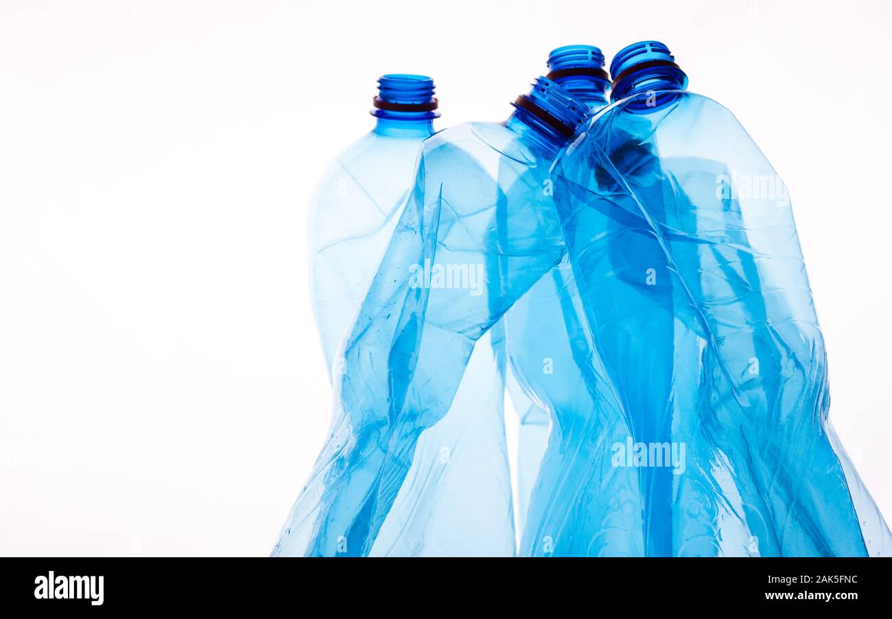 Crumpled plastic bottles of mineral water on white background. Plastic waste concept Stock Photo