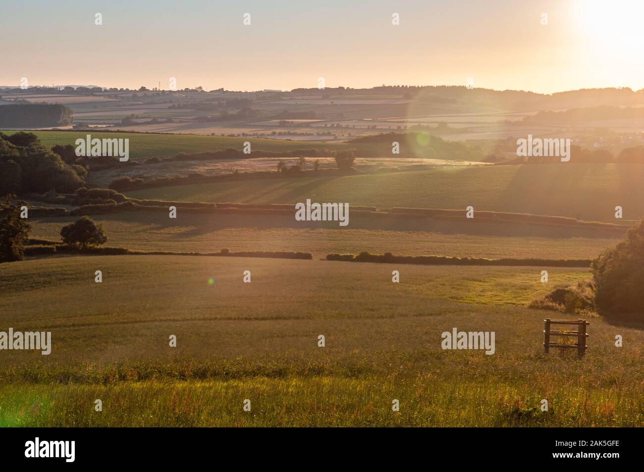 The sun sets over the rolling agricultural landscape of the Yeo Valley at Sherborne in West Dorset. Stock Photo