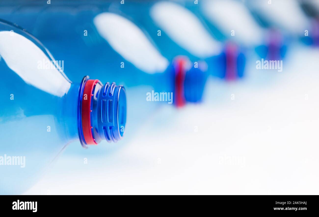 Environment concept. Set of water plastic bottles in a raw isolated on