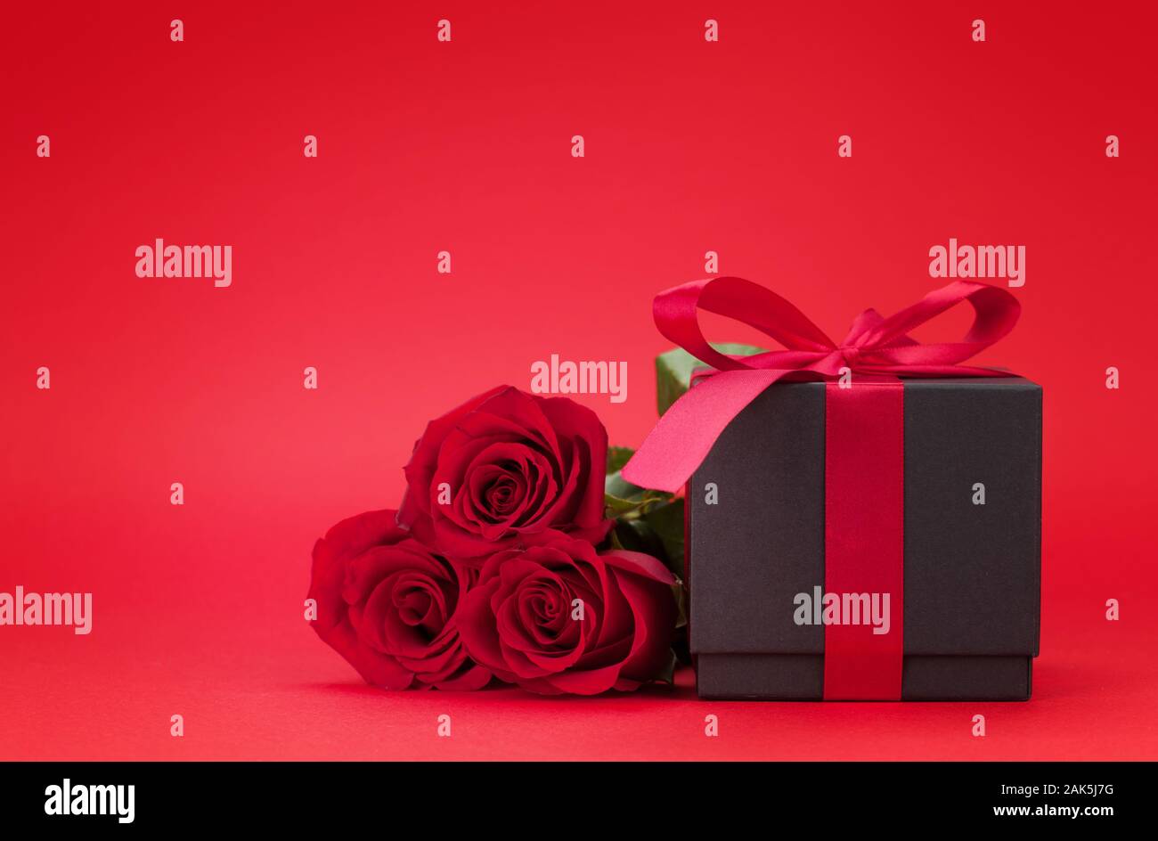 Valentines day greeting card with rose flower bouquet and gift box over ...