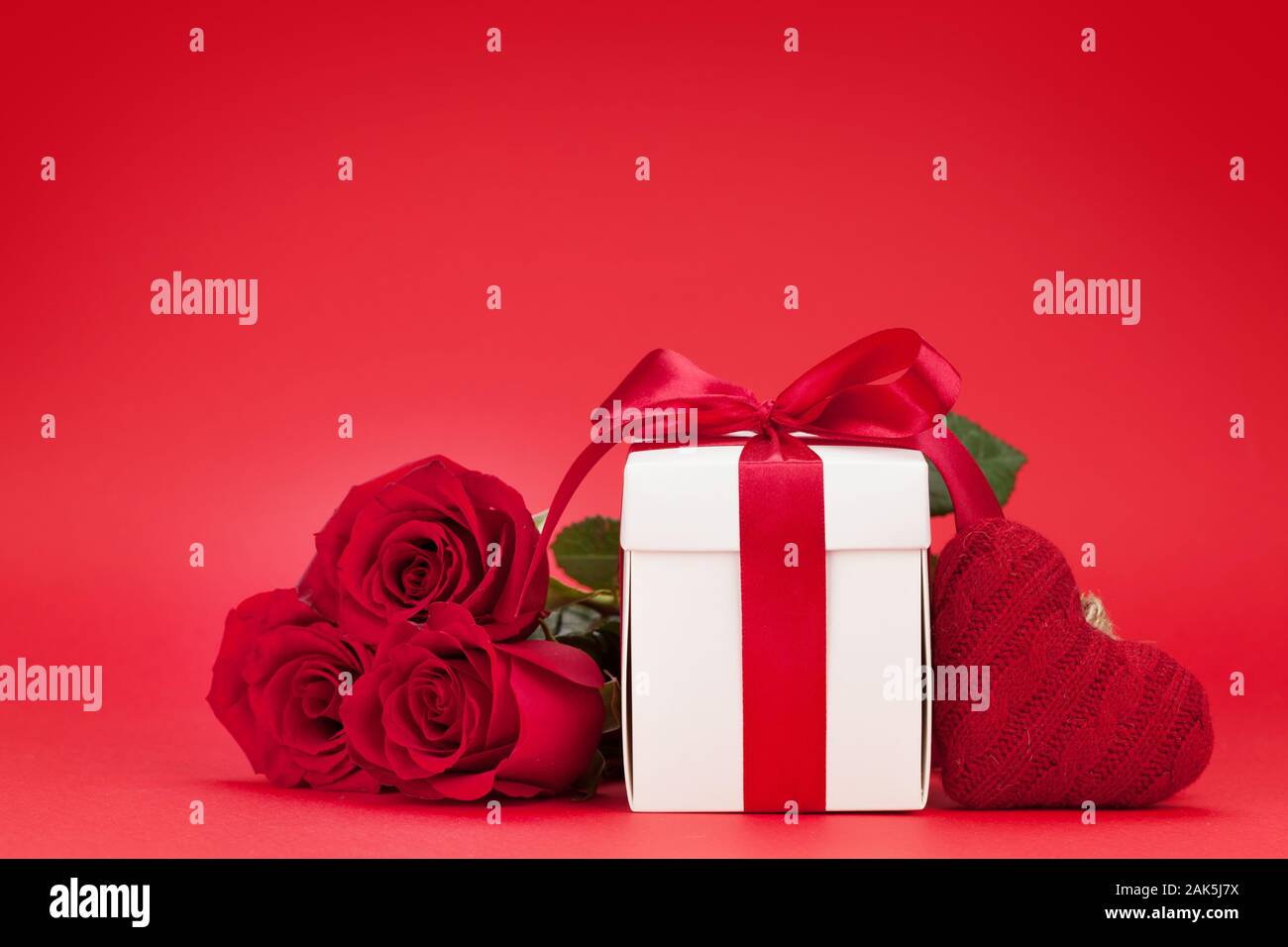 Valentines day greeting card with rose flower bouquet and gift box over ...