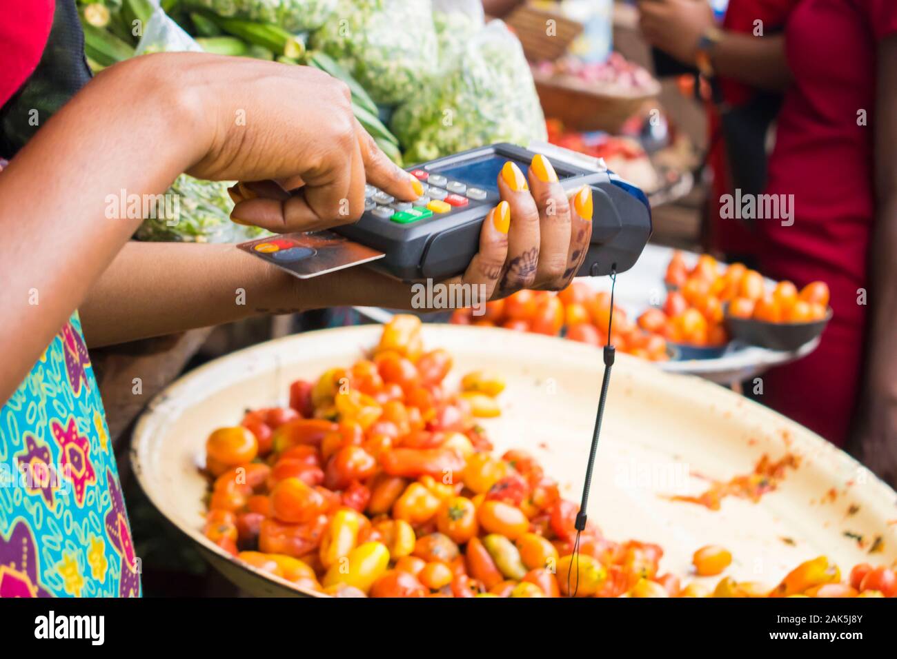 close up of an african woman selling in a local african market using a
