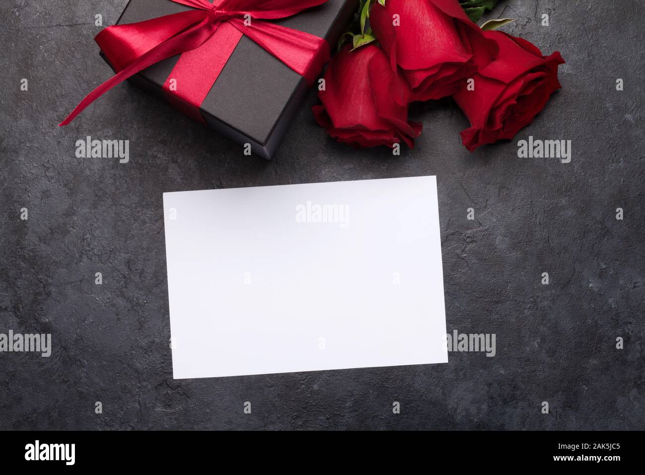 Valentines day greeting card with rose flower bouquet and gift box over ...