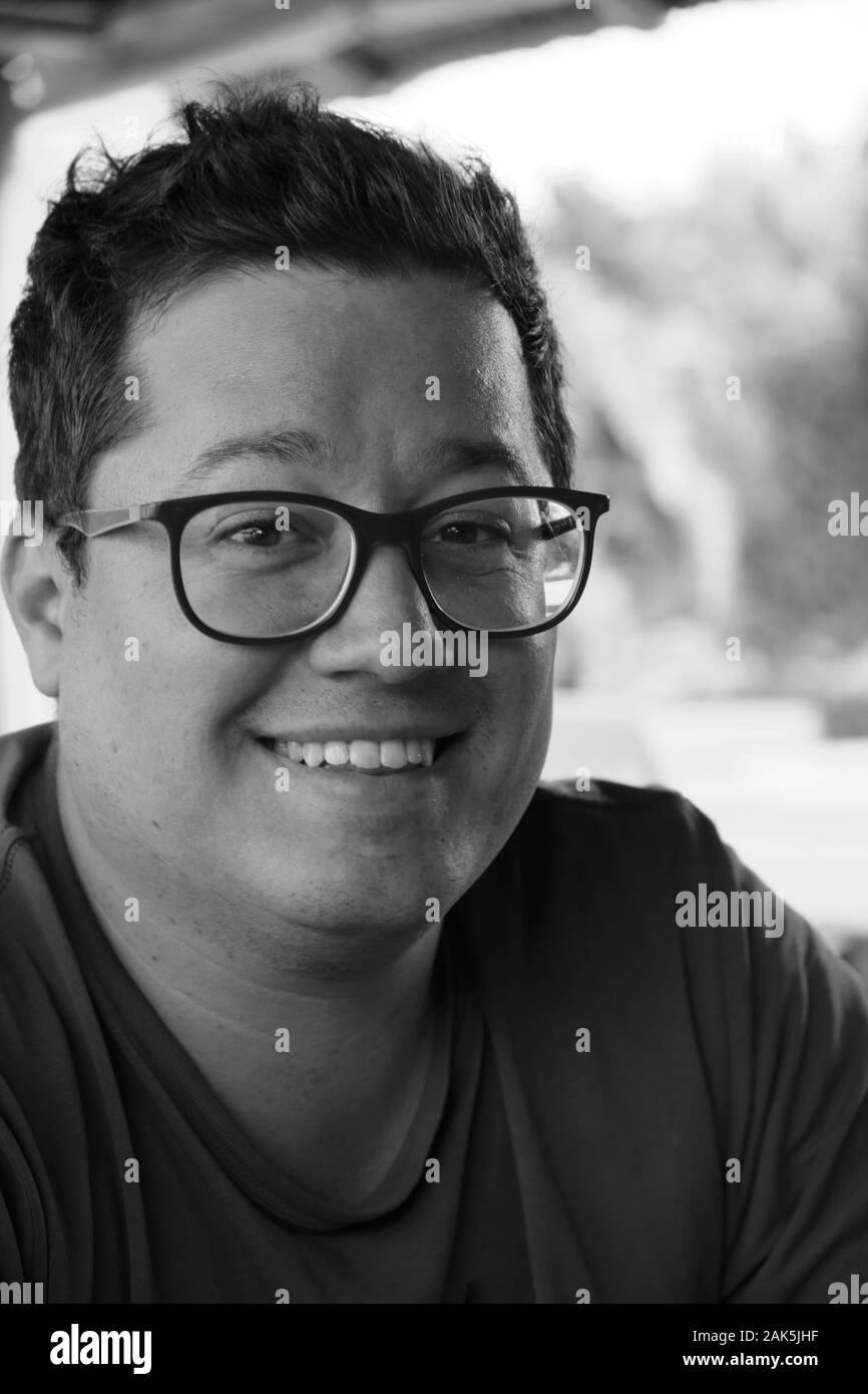 black and white portrait of a men with a happy expression in his face Stock Photo