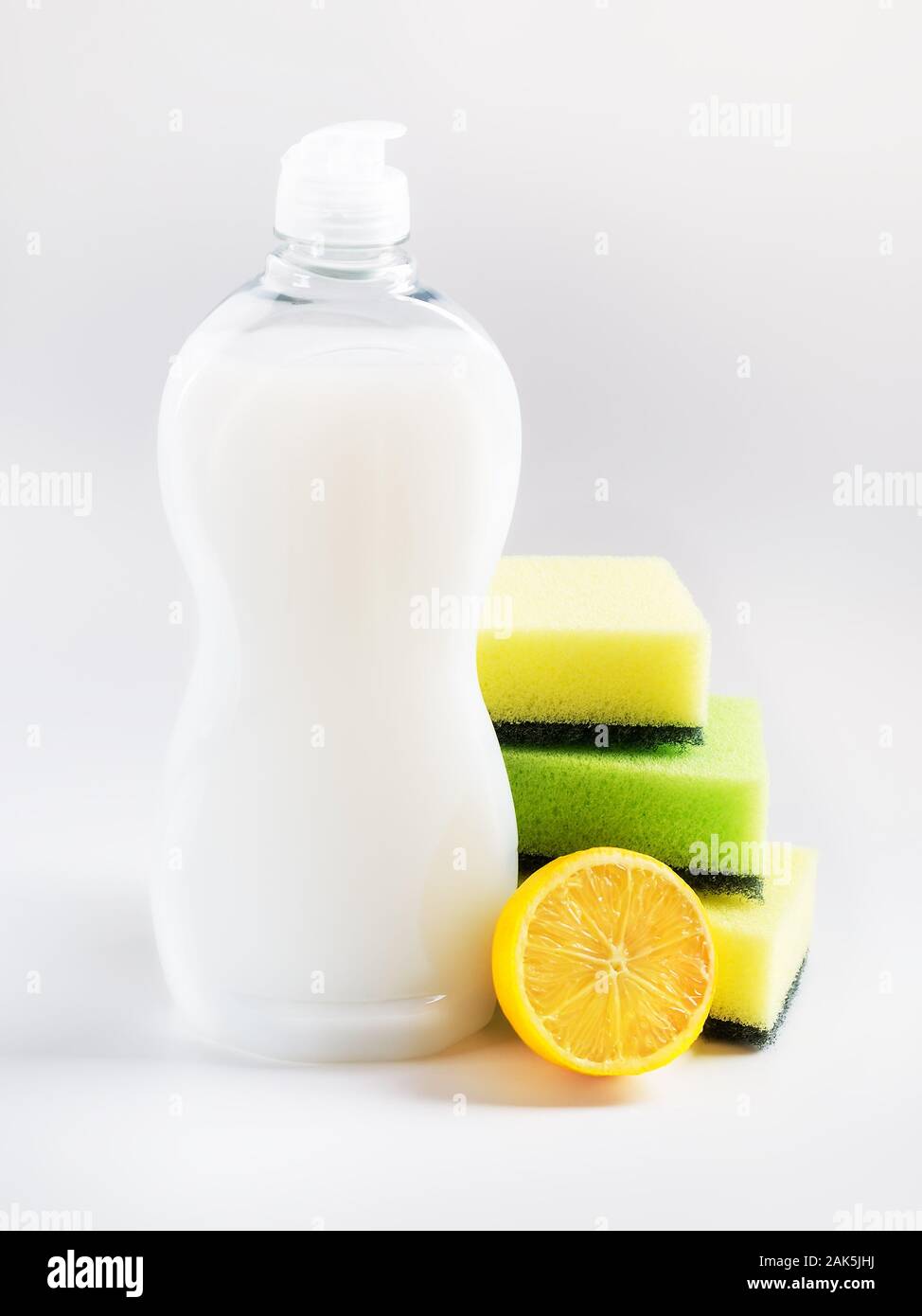 White dishwashing liquid in a plastic bottle, three foam sponges and