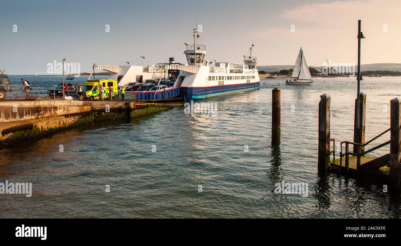 Poole, England, UK - July 30, 2011: Traffic including an ambulance disembark from the Sandbanks to Studland ferry at Poole Harbour in Dorset. Stock Photo