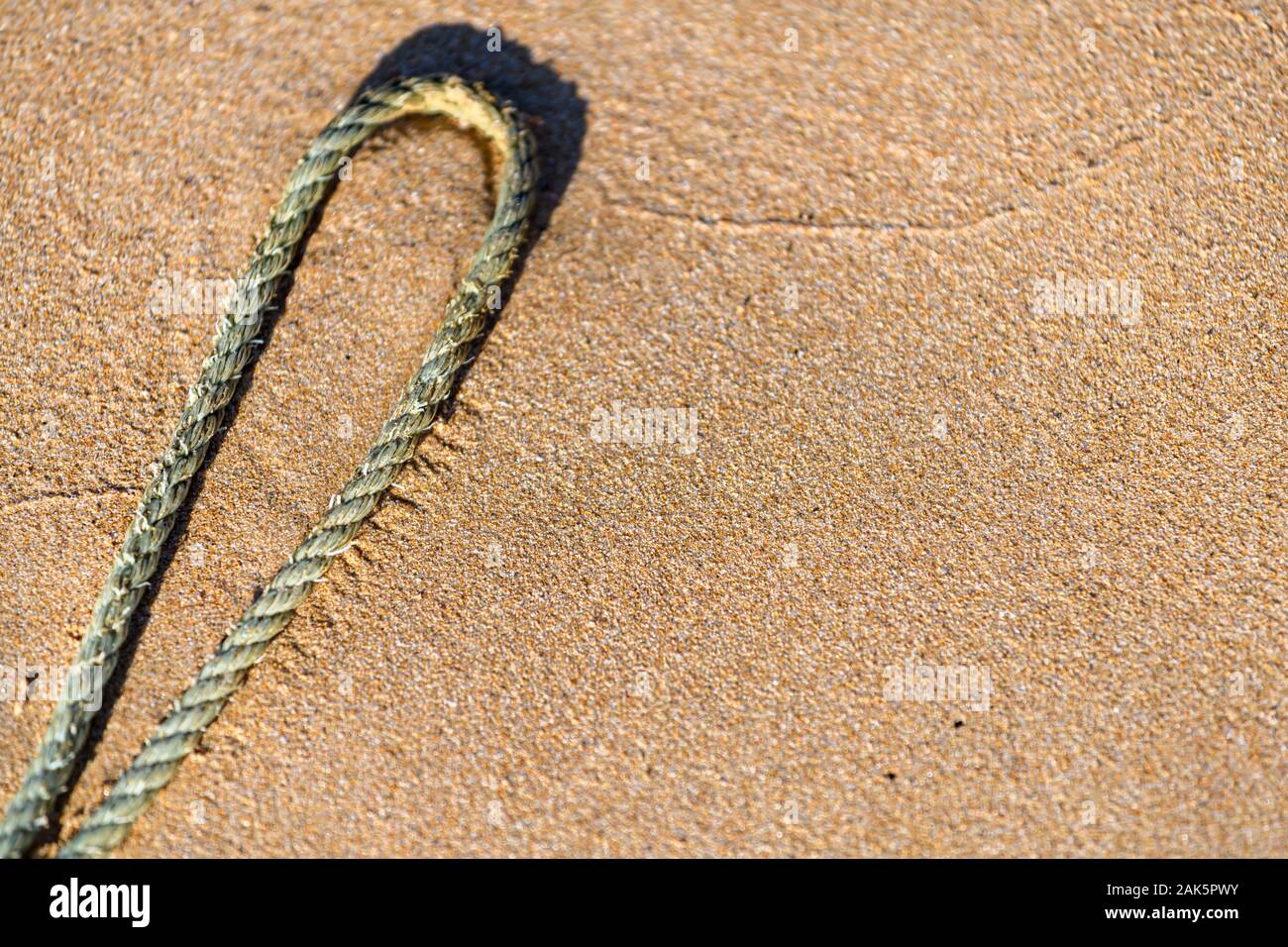 Rope on a golden sandy beach Stock Photo
