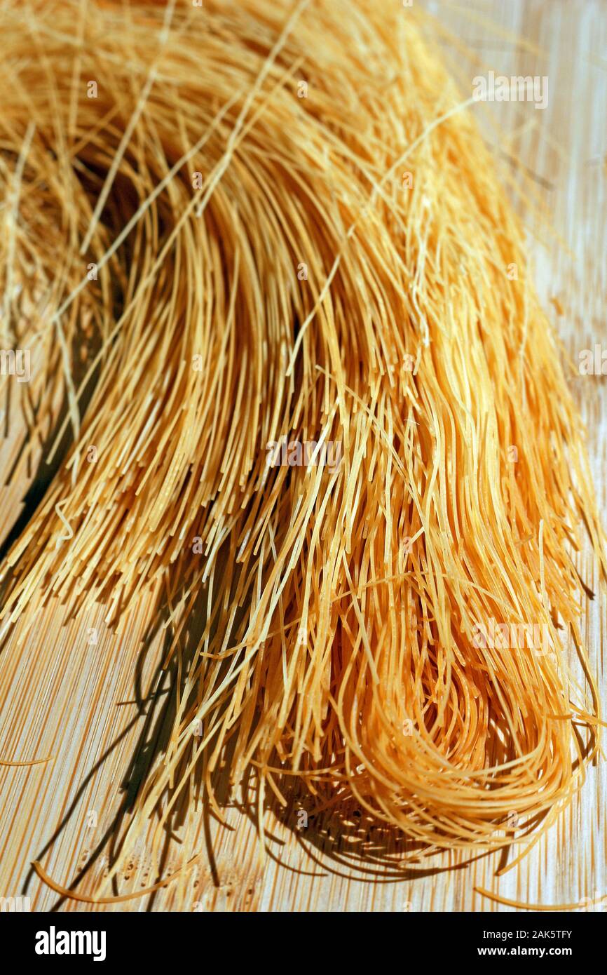 Rice Vermicelli Pasta on a Wooden Background Stock Photo