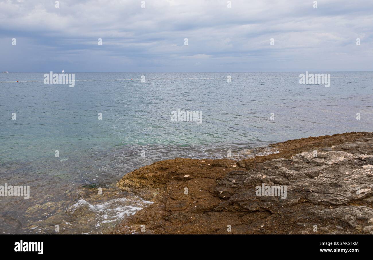 View on Adriatic sea at stormy day with big rocks. Region Istria, near the Rovinj city. Republic of Croatia Stock Photo