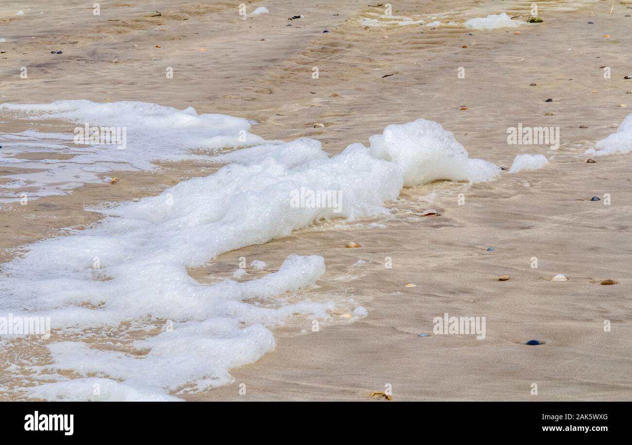 coastal closeup showing some spume and sand Stock Photo