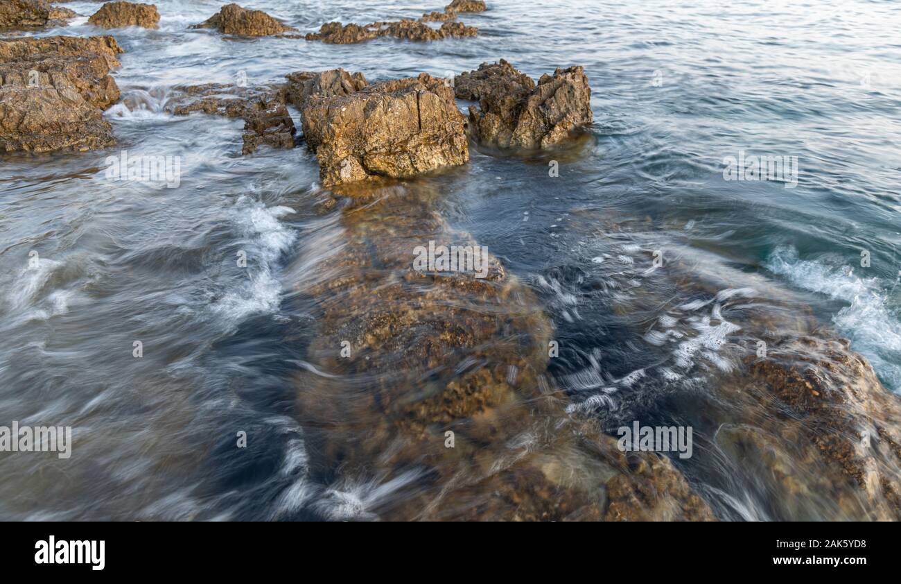 View on Adriatic sea at stormy day with big rocks. Region Istria, near the Rovinj city. Republic of Croatia Stock Photo
