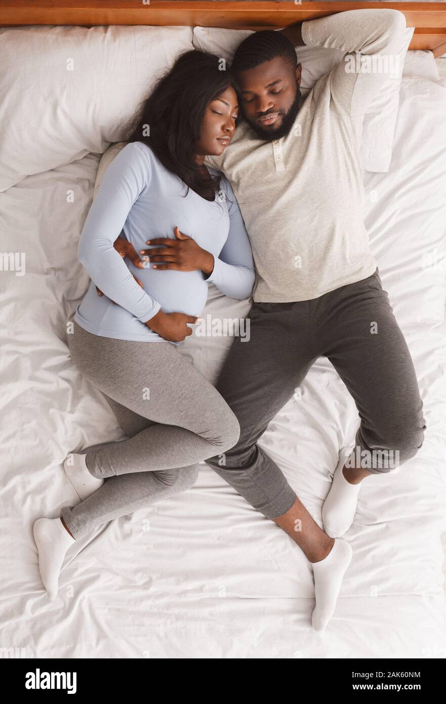 African couple laying in bed hi-res stock photography and images - Alamy