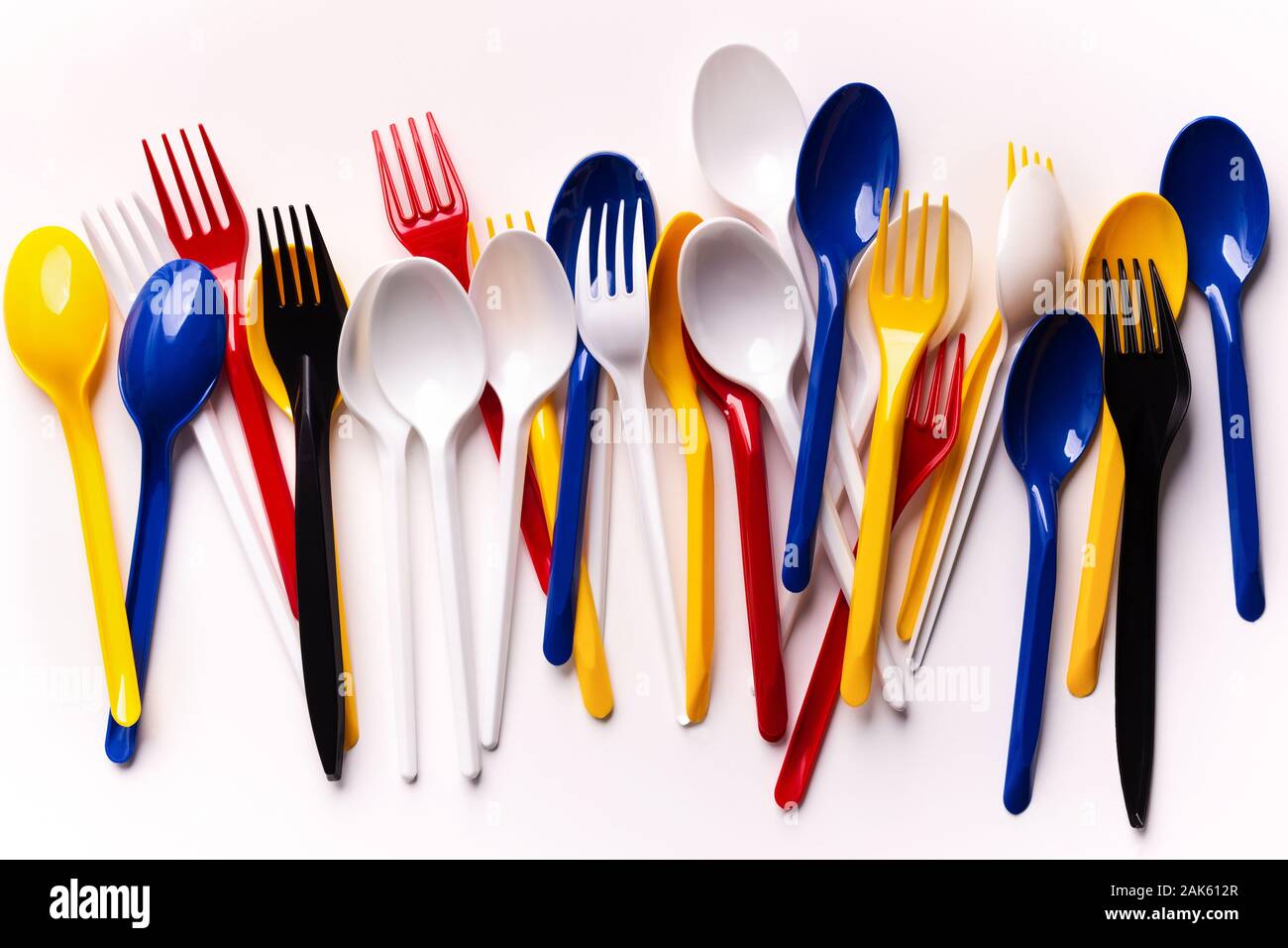 Say no to plastic usage. Colored plastic forks and spoons isolated on