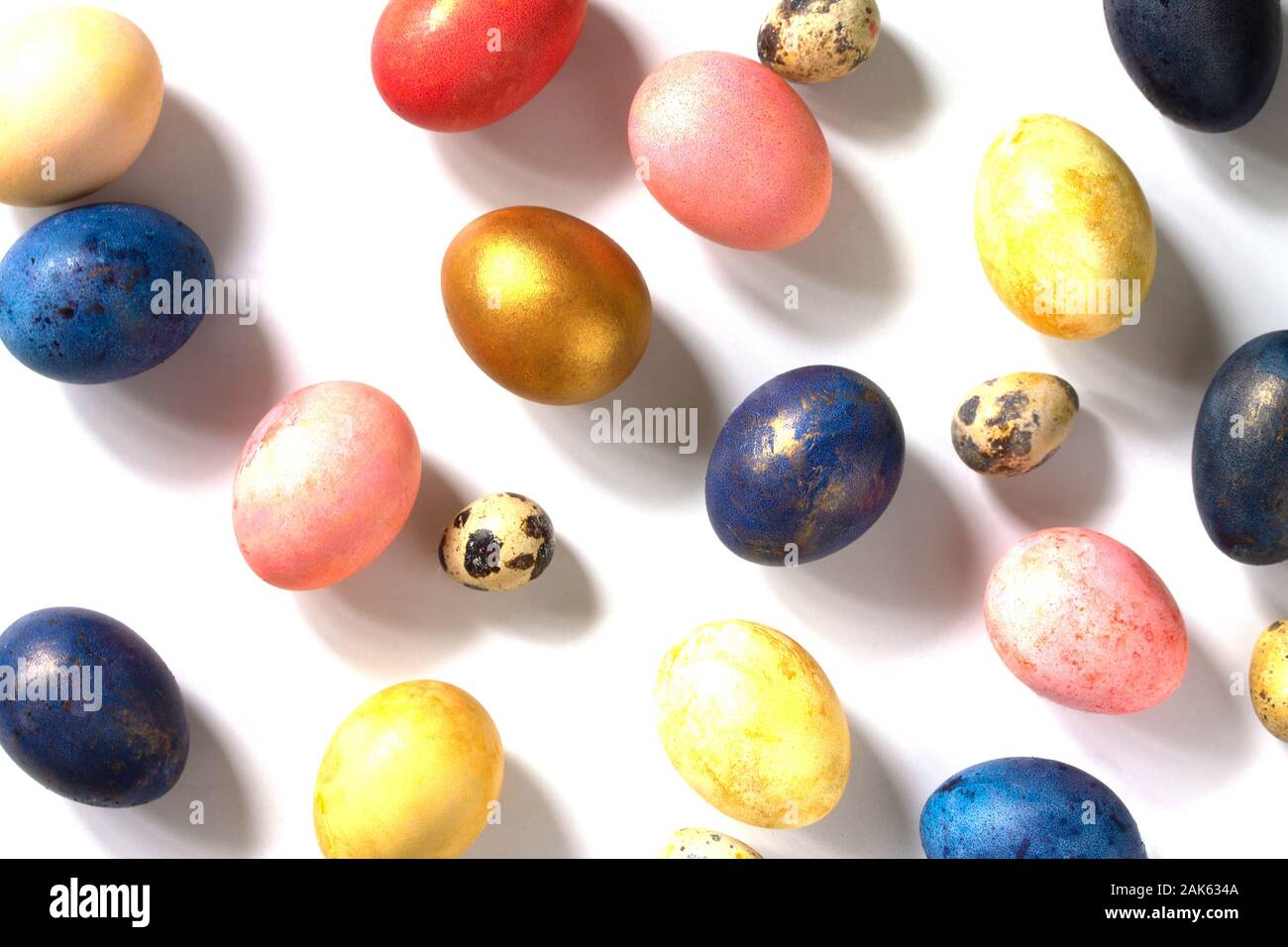 Decorative multi-colored Easter eggs in a nest on a white background. Stock Photo