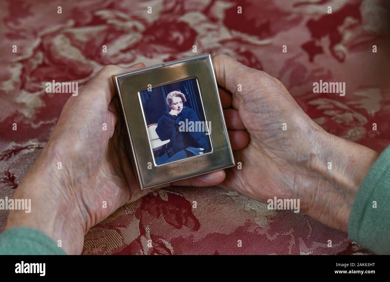 Symbol photo, mother love, hands of an old woman holding picture frame with a young woman, daughter, memory, Germany Stock Photo