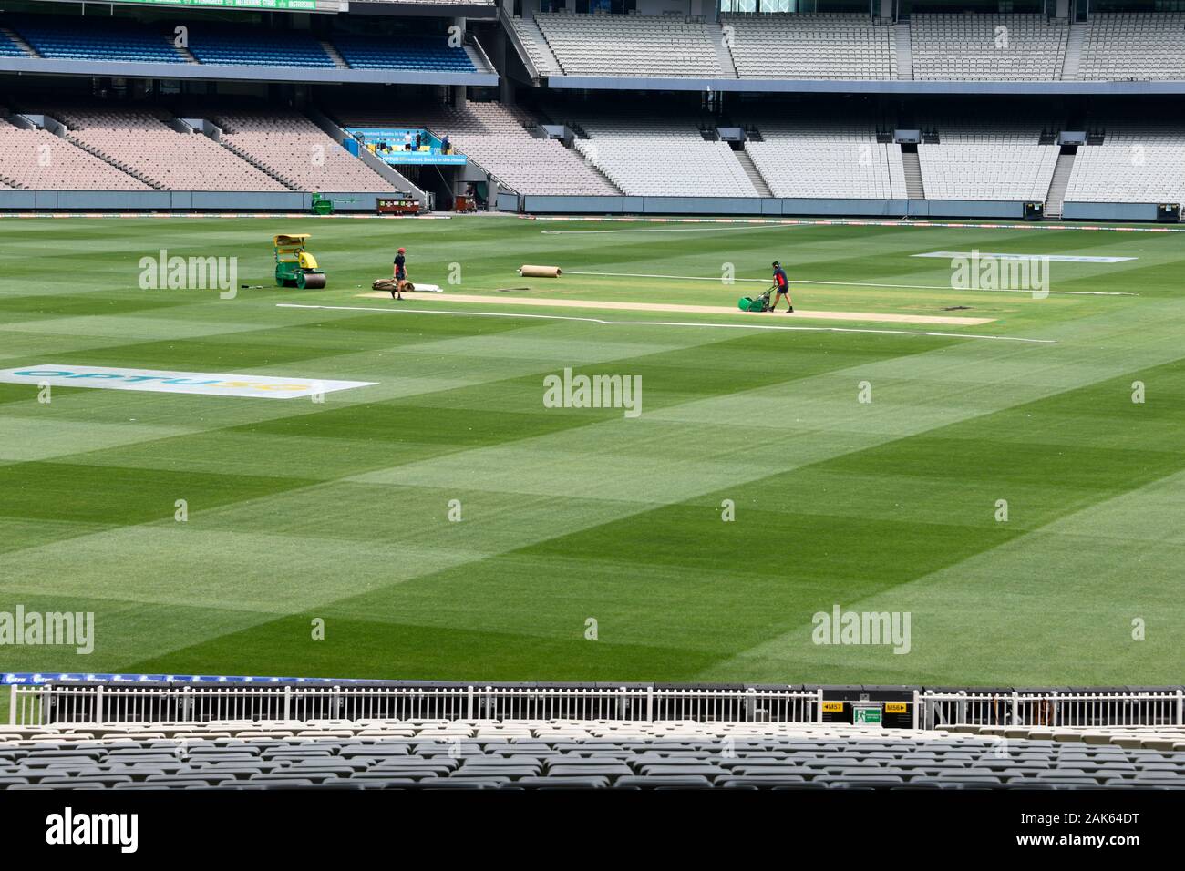 Cricket Pitch preparation at the MCG - Melbourne Cricket Ground), with green grass, workers and seating. Stock Photo