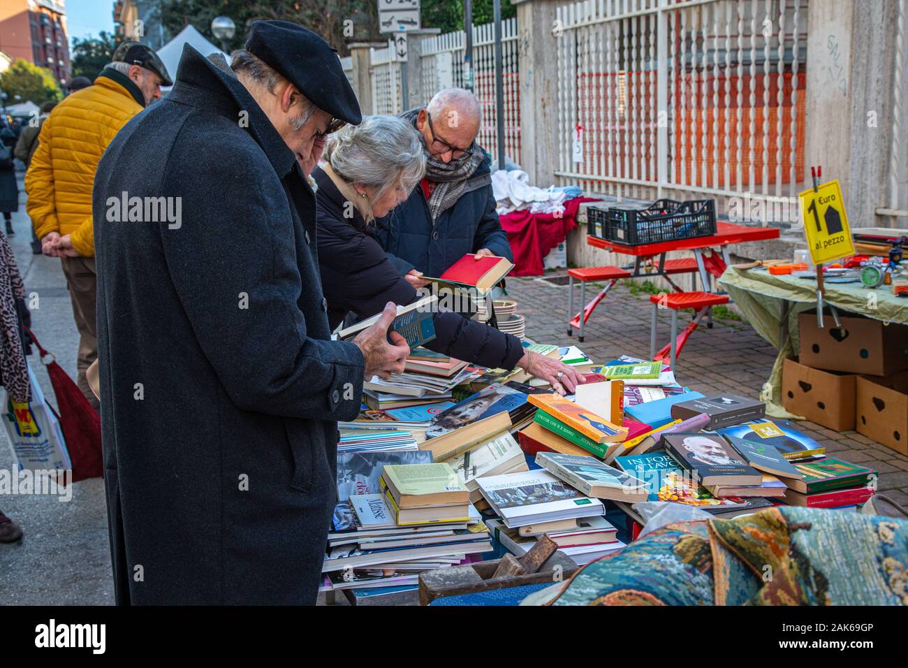 elderly people at the second-hand book stall  in  flea market. Pescara, Italy Stock Photo