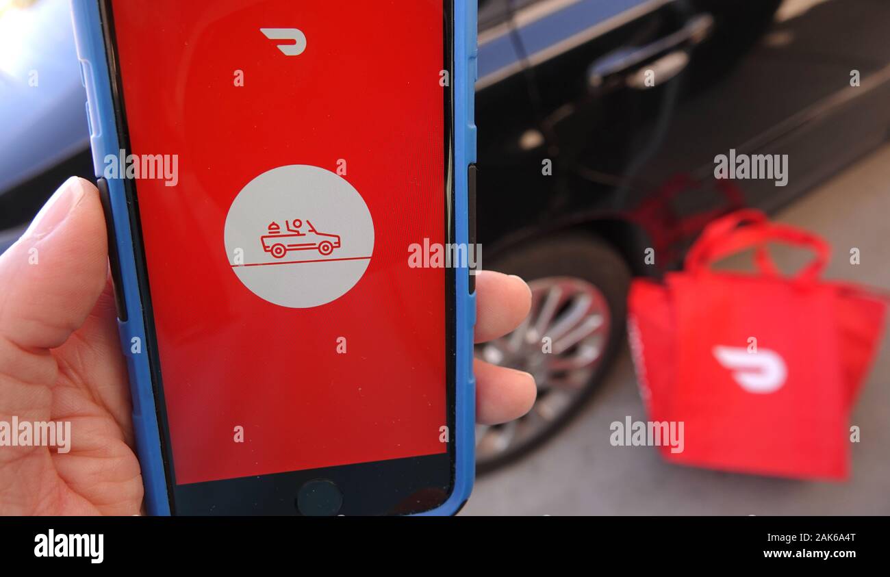Close up of mobile phone screen with Dasher app from Doordash launching