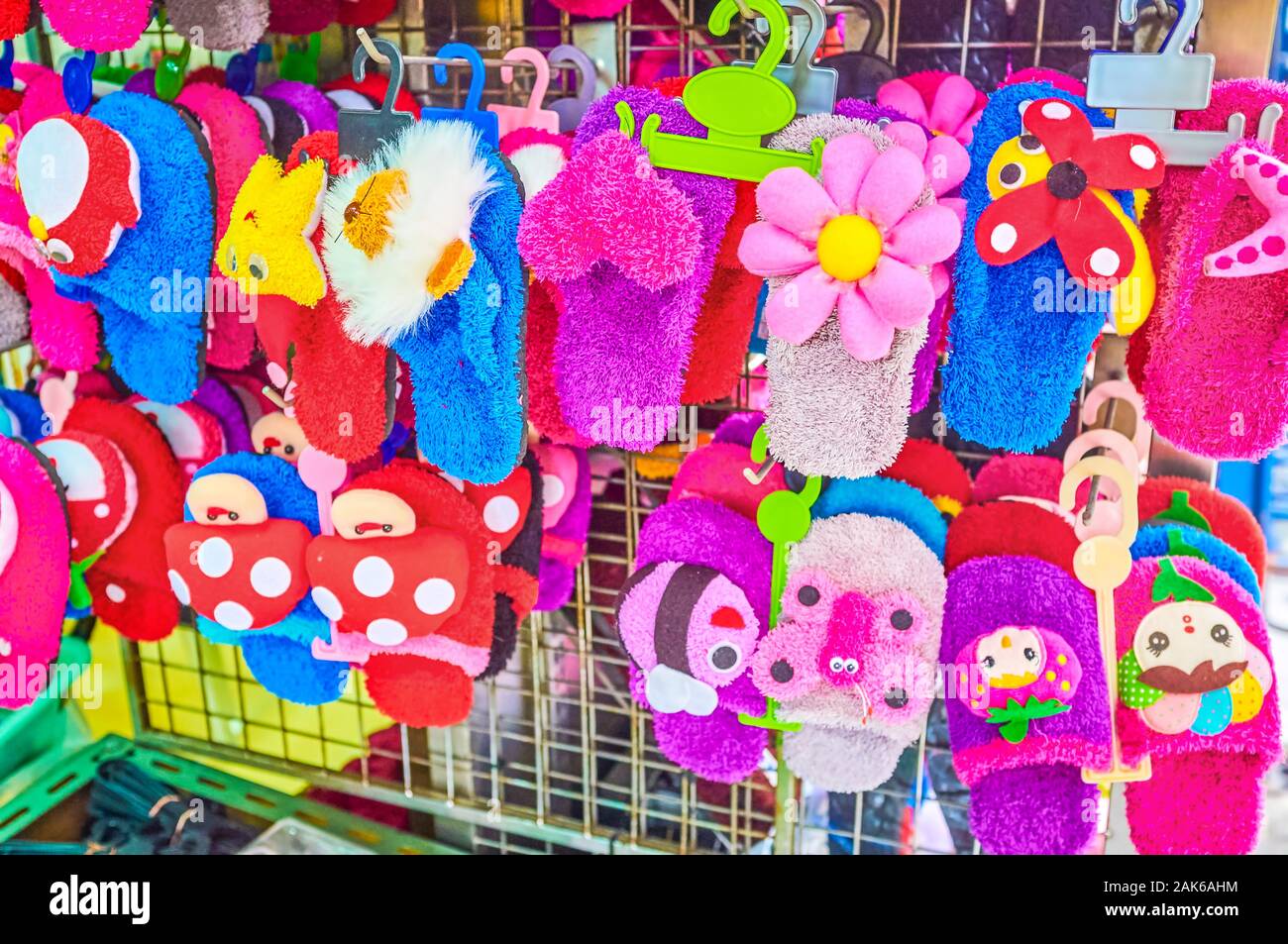 The beautiful colorful kid's home slippers on the stall in Chinatown's market in Bangkok, Thailand Stock Photo