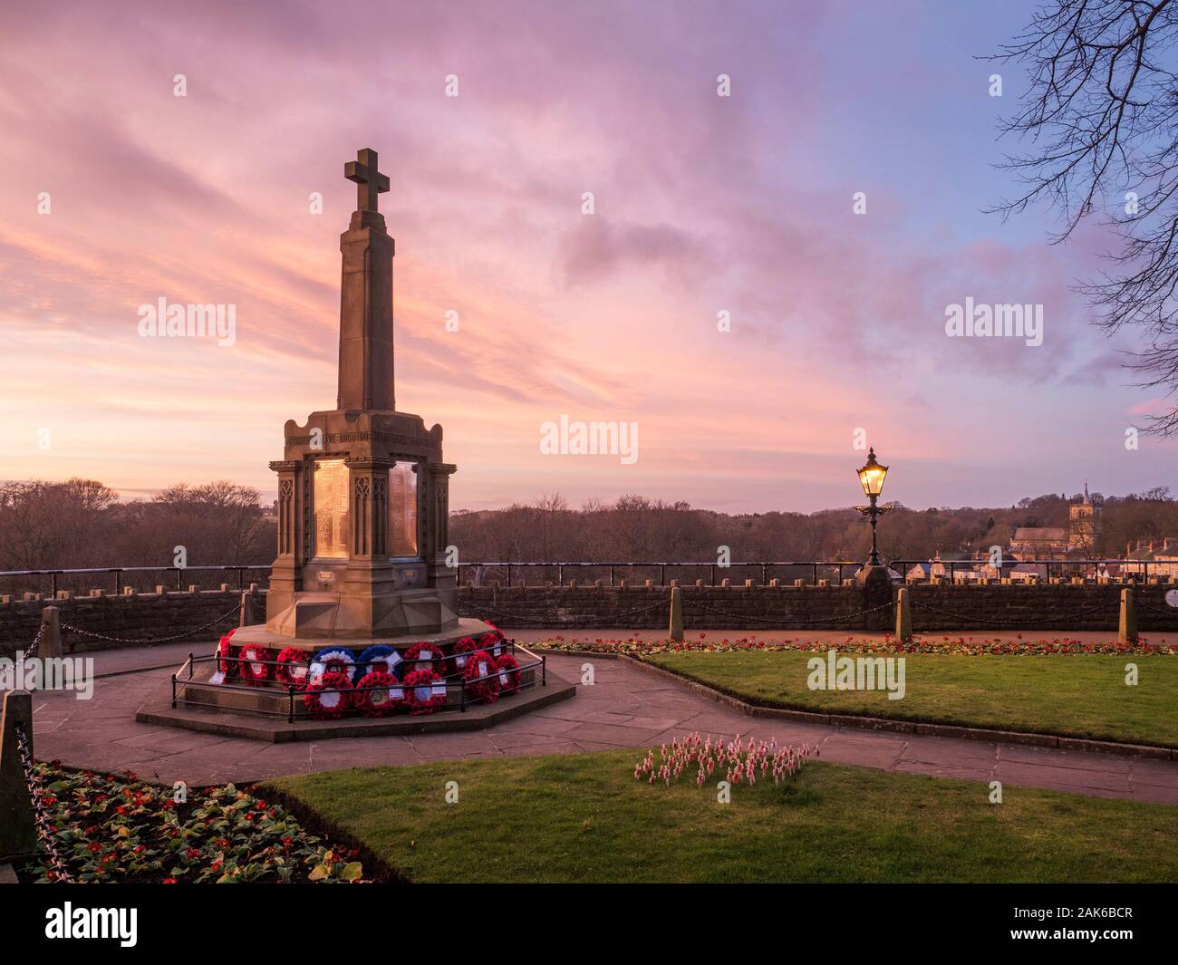 Pink sky at dusk over the War Memorial in the Catle Grounds at Knaresborough North Yorkshire England Stock Photo