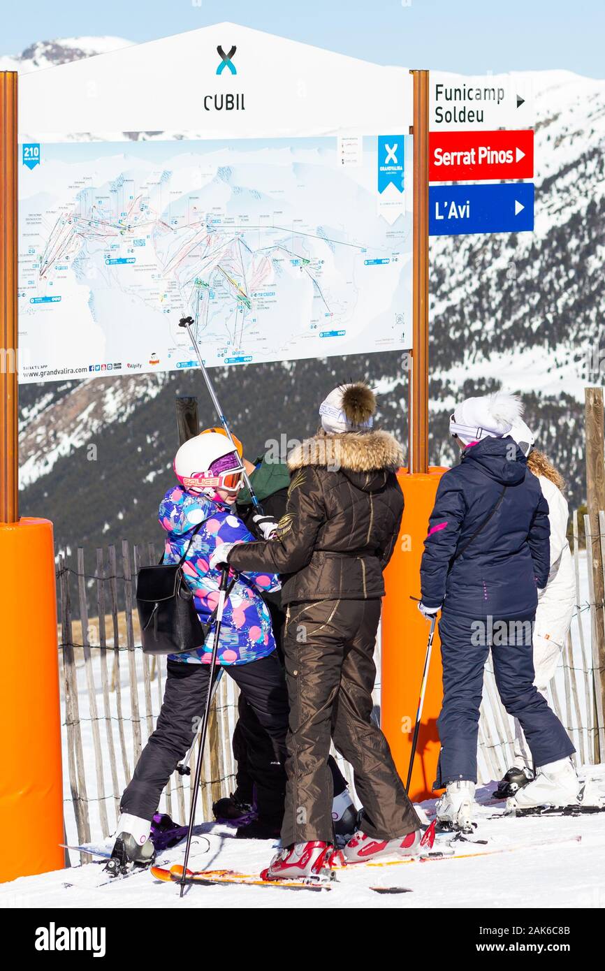 PYRENEES, ANDORRA - FEBRUARY 15, 2019: Unknown tourists are looking at the circuit on the mountainside in a ski resort. Stock Photo
