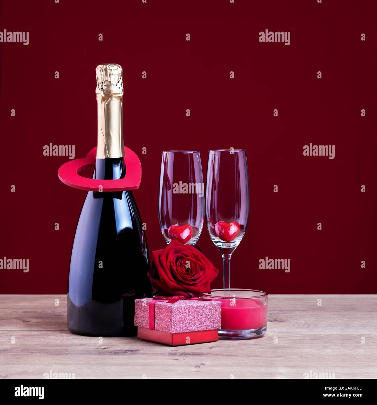 Greeting card for Womens or Mothers day. Valentines day concept with champagne glasses candle and hearts. Stock Photo