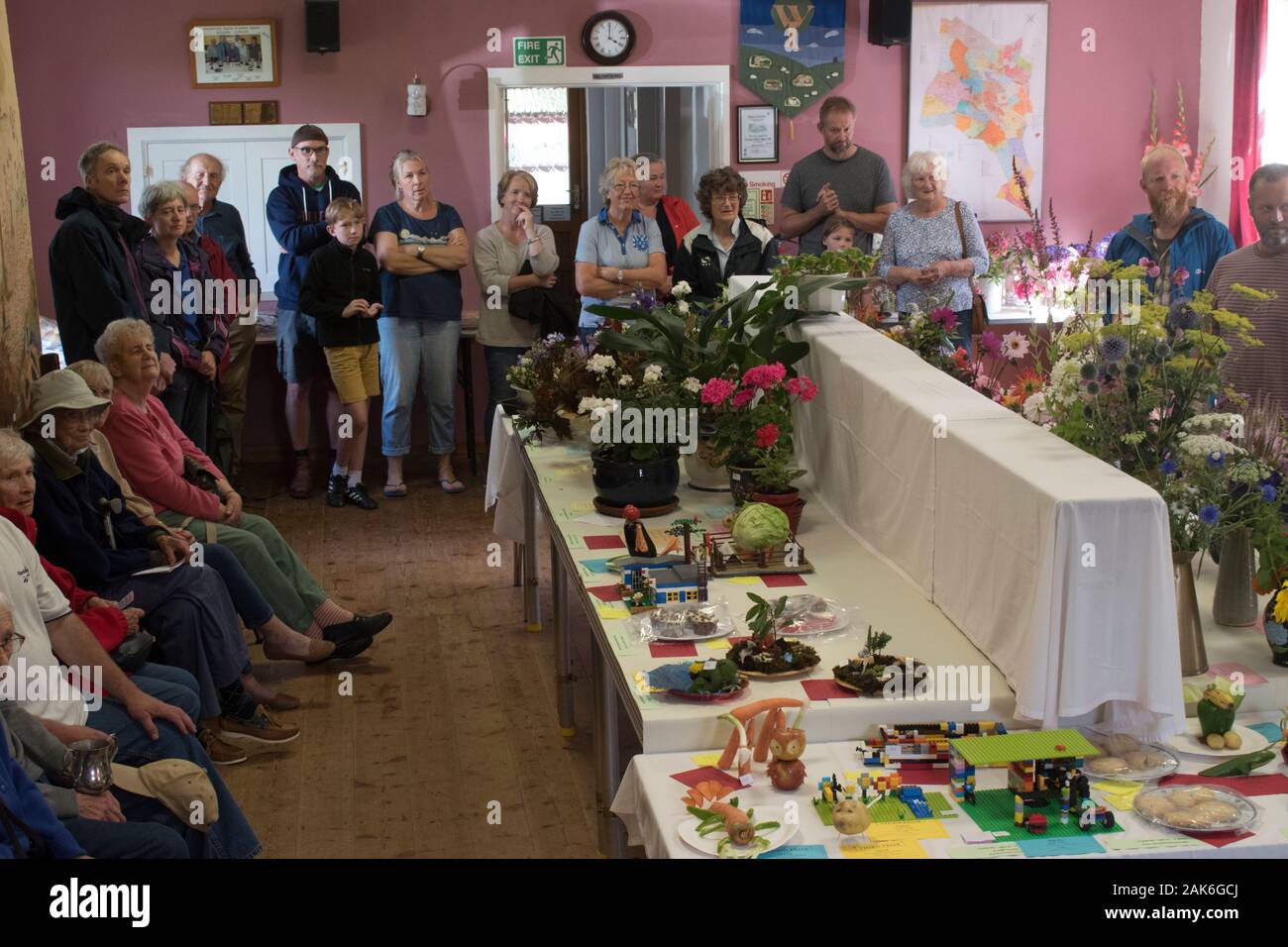Annual Village Show UK. Community event flowers and home grown produce, vegetables, childrens make animals and funny faces made from vegetables. All displayed in the village hall. Brompton Ralph, Somerset. People tturn out of the view of the judges. 2010s 2019 HOMER SYKES Stock Photo
