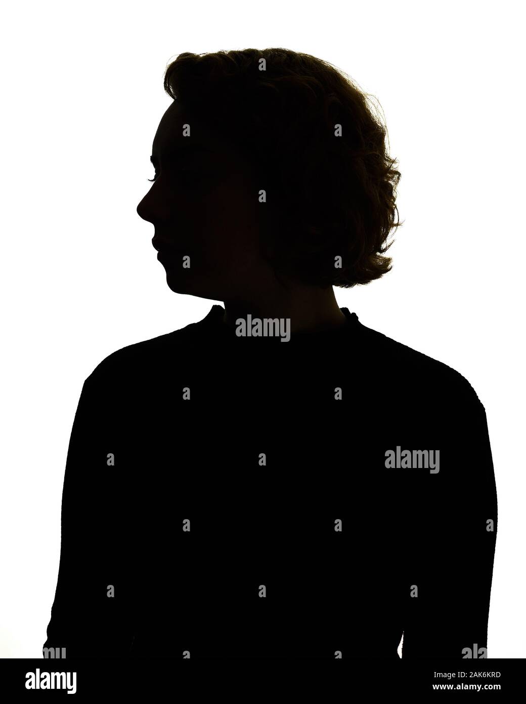 Silhouette of head and shoulders of a woman, backlit. Stock Photo