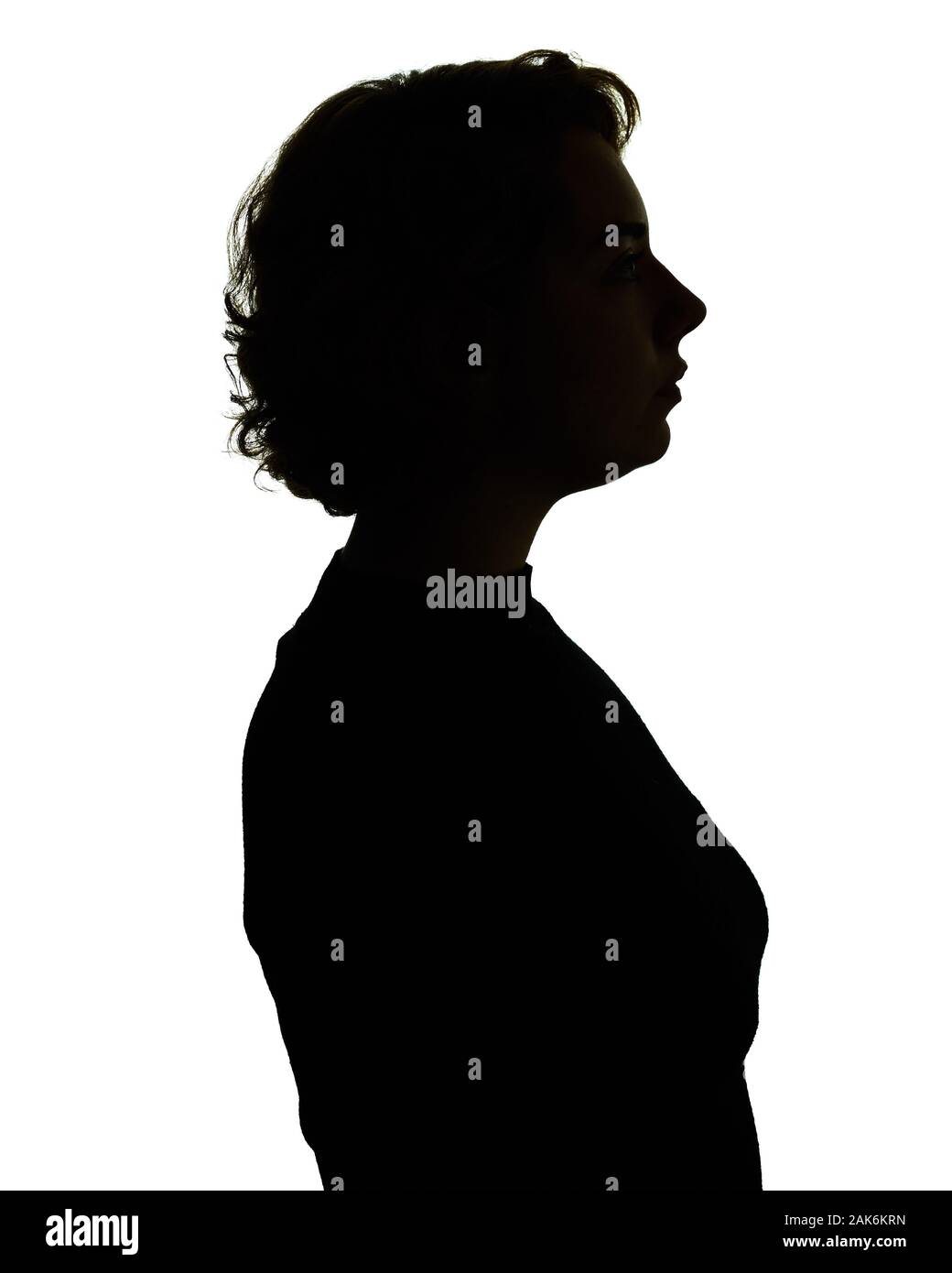 Silhouette of head and shoulders of a woman, backlit. Stock Photo