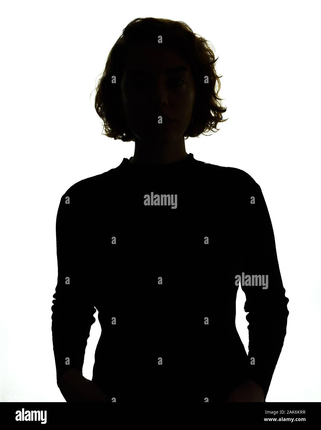 Silhouette of head and shoulders of a woman, backlit. Stock Photo
