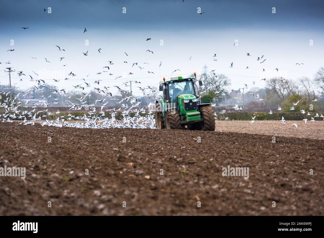John Deere Green Tractor Plowing on the Nottinghamshire Lincolnshire,UK. Stock Photo