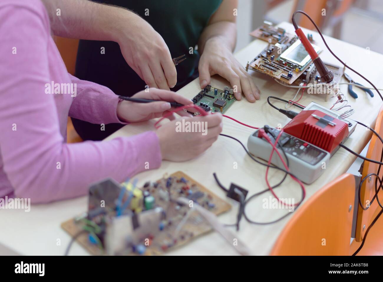 Group of young engineers working on robotics project. Scientist ...