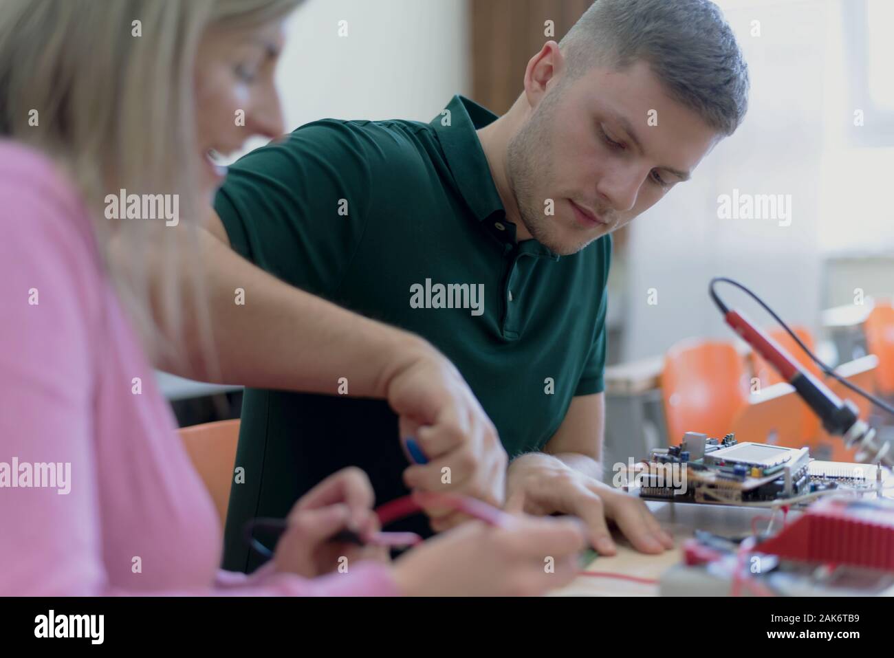 Group of young engineers working on robotics project. Scientist ...