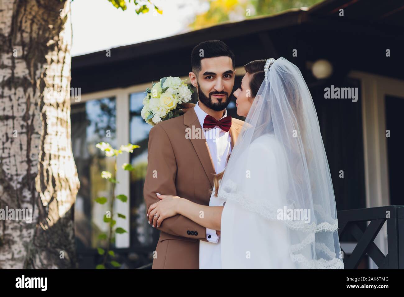 Bride and groom on the porch of an old cottage Stock Photo - Alamy