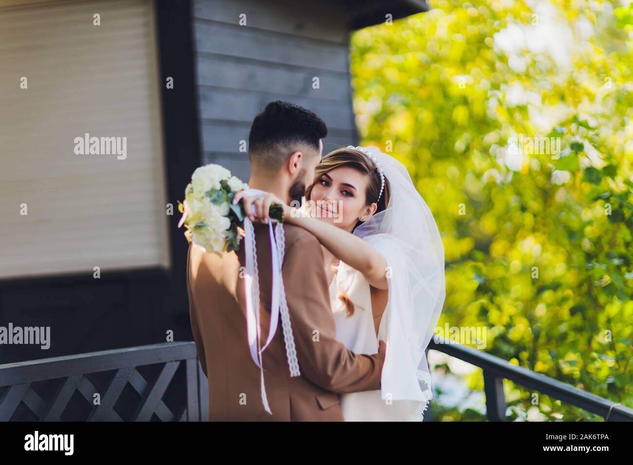 Bride and groom on the porch of an old cottage Stock Photo - Alamy