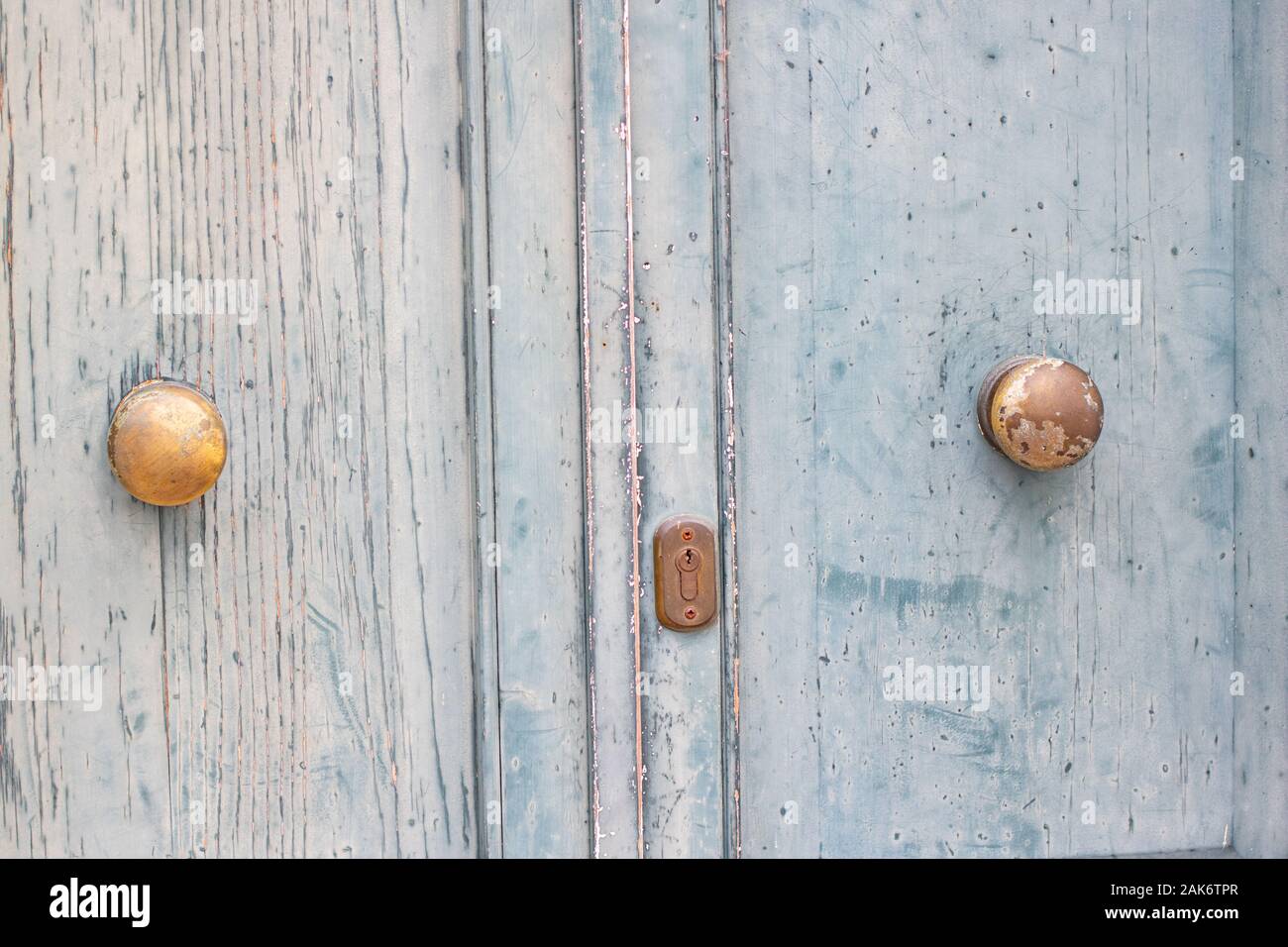 Old vintage, pale blue double wooden doors, gold handles, background, concept Stock Photo
