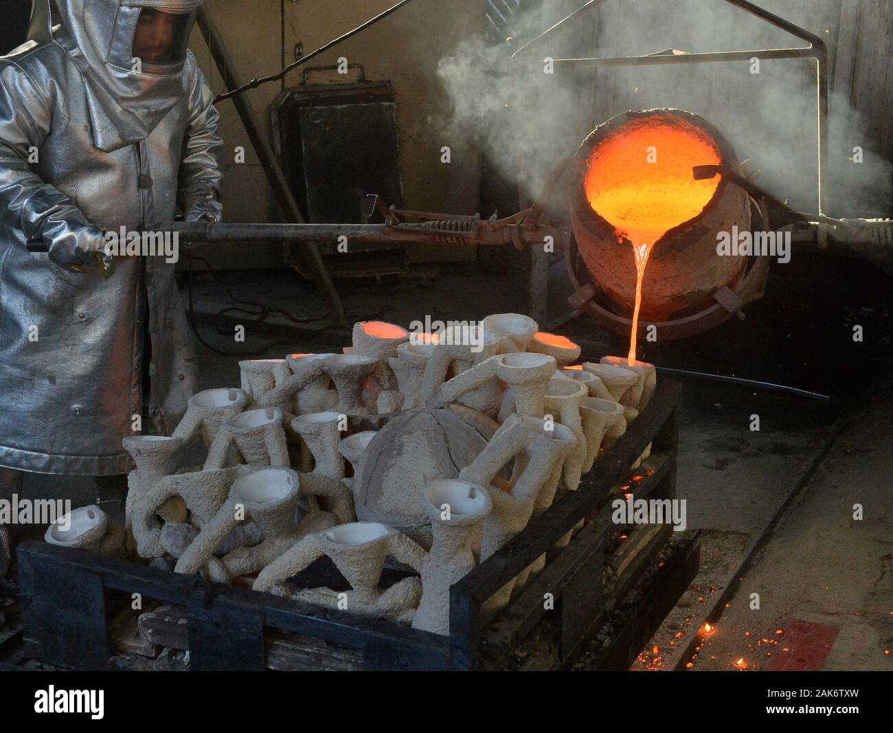 Workers in fire suits pour molten bronze metal into molds during the casting of the Screen Actors Guild Award statuettes at the American Fine Arts Foundry in Burbank, California on Tuesday, January 7, 2020. Winners are to be announced during a live simulcast on TNT and TBS in Los Angeles on January 19, 2020. Photo by Jim Ruymen/UPI Credit: UPI/Alamy Live News Stock Photo