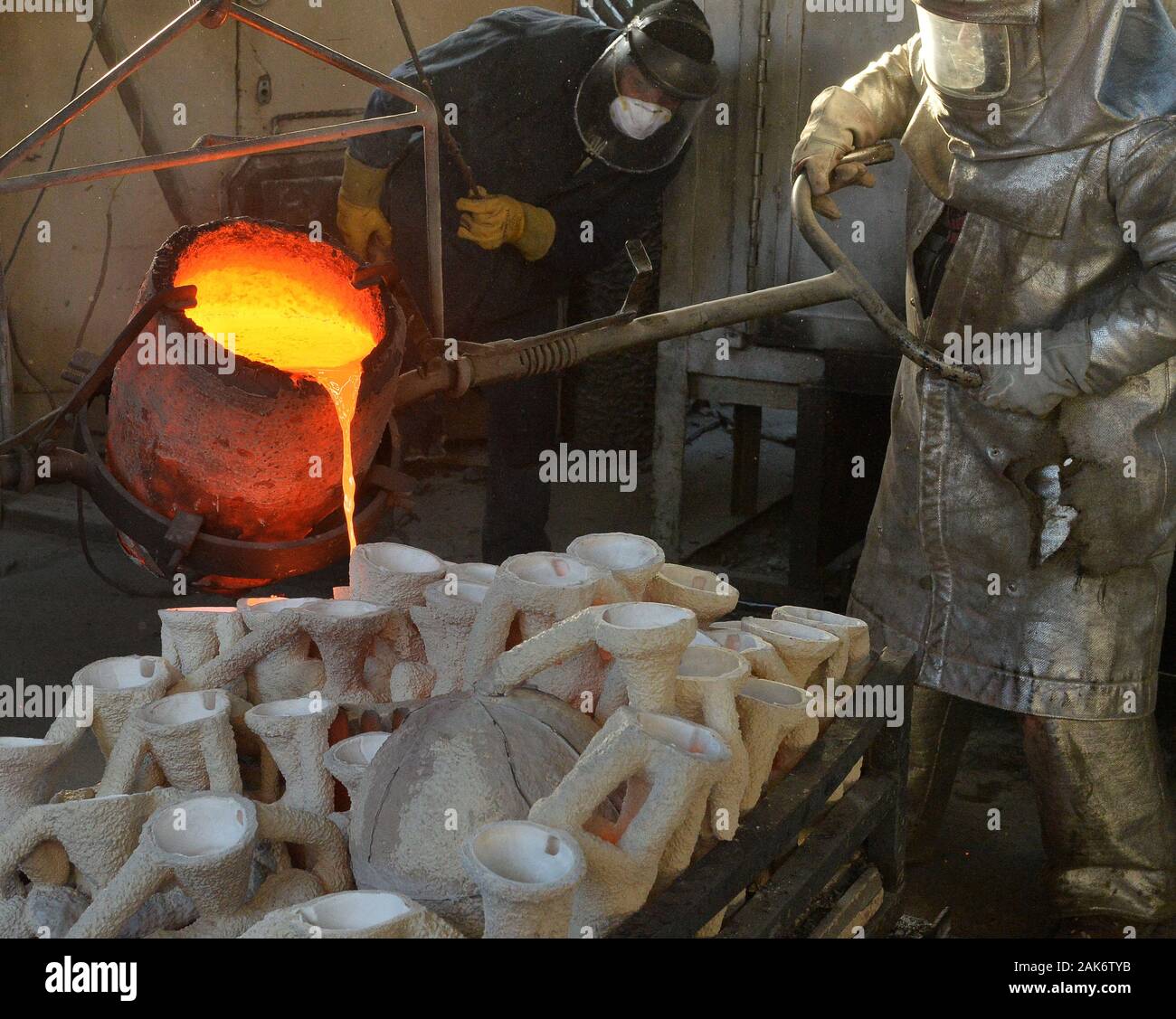 Workers in fire suits pour molten bronze metal into molds during the casting of the Screen Actors Guild Award statuettes at the American Fine Arts Foundry in Burbank, California on Tuesday, January 7, 2020. Winners are to be announced during a live simulcast on TNT and TBS in Los Angeles on January 19, 2020. Photo by Jim Ruymen/UPI Credit: UPI/Alamy Live News Stock Photo