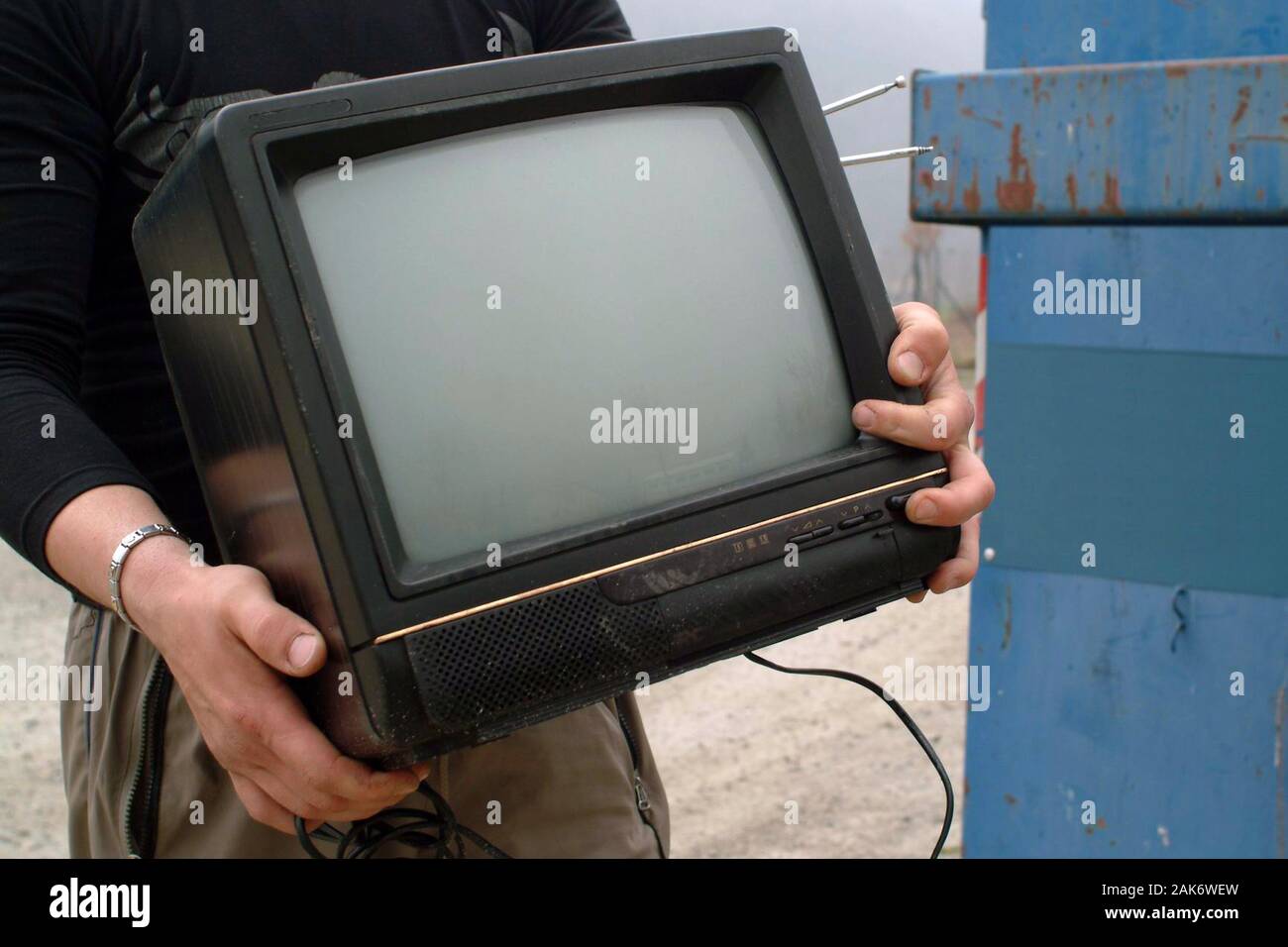 An old a TV properly disposed of in the waste for recycling Stock Photo