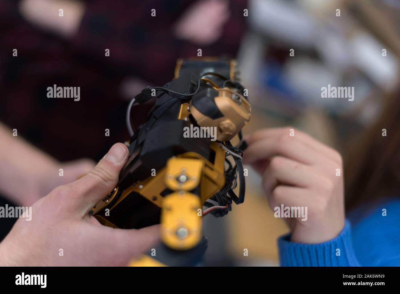 Group of young engineers working on robotics project. Scientist ...