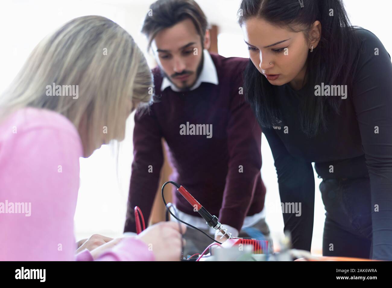 Group of young engineers working on robotics project. Scientist ...