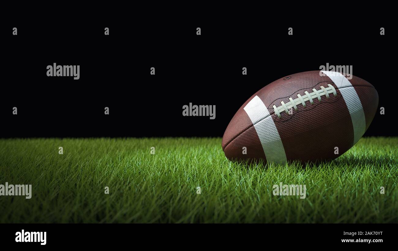 American football on green grass, on black background - 3D illustration Stock Photo