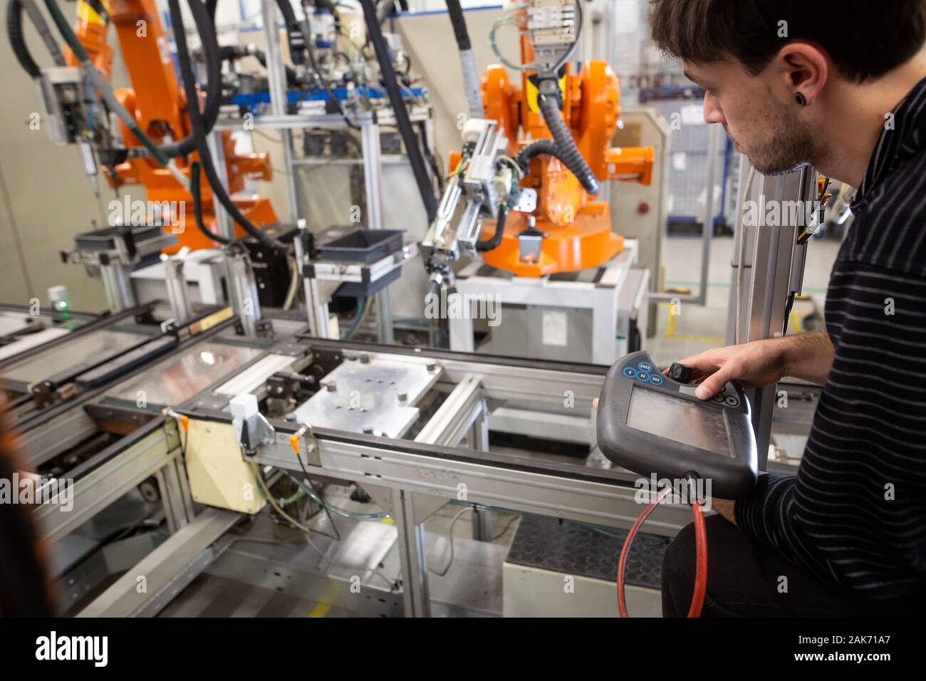 Man programming robot in automotive industrial, professional programmer, industry concept Stock Photo