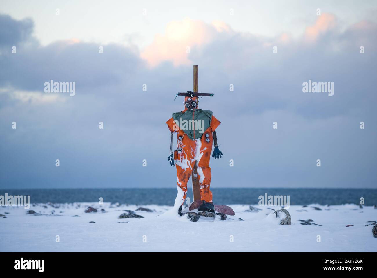 Old diving suit in the form of a mannequin on the shore of the Arctic Ocean on a February day. Teriberka, Russia Stock Photo