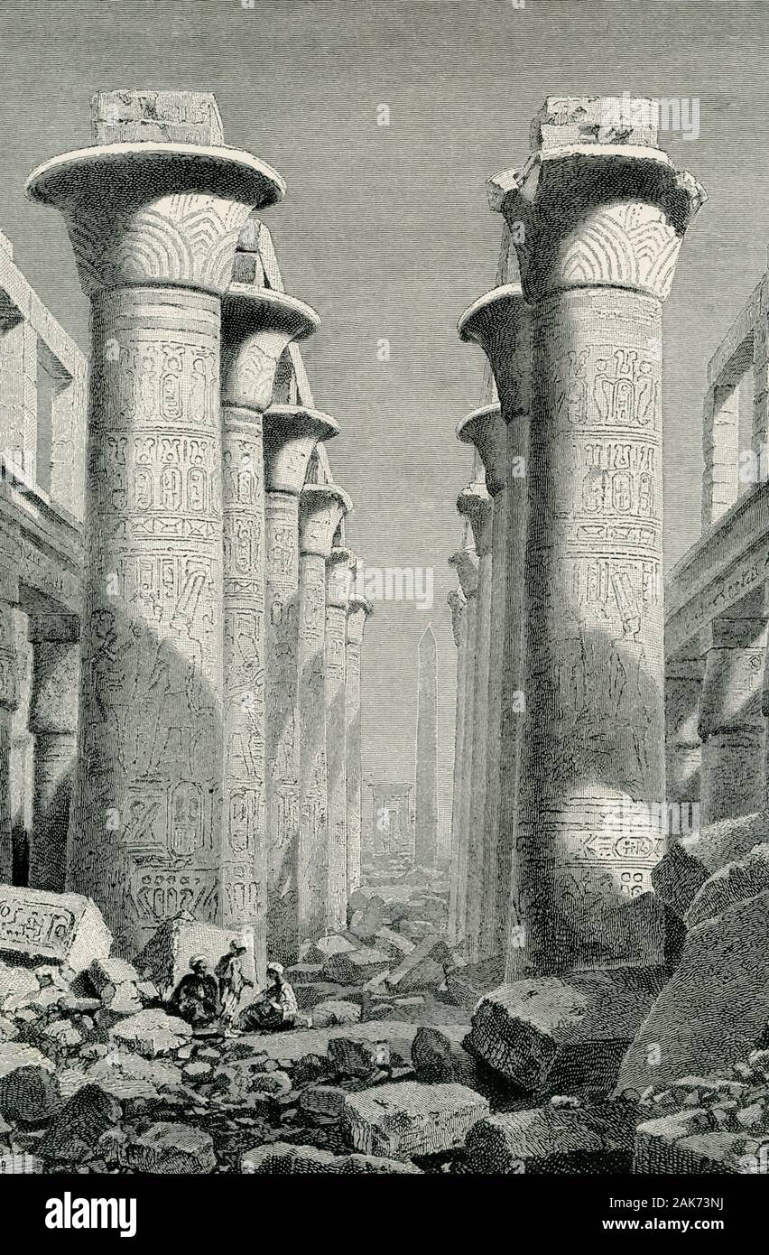 This illustration of the ruins of the  Hall of Columns at Karnak dates to the early 1900s. The Great Hypostyle Hall Karnak is composed of 134 giant sandstone columns in the form of papyrus stalks. Twelve great columns in its central nave are 70-plus feet in height and are capped by huge open papyrus blossom capitals. The main east-west axis of the Hypostyle Hall is dominated by a double row of 12 giant columns. Stock Photo