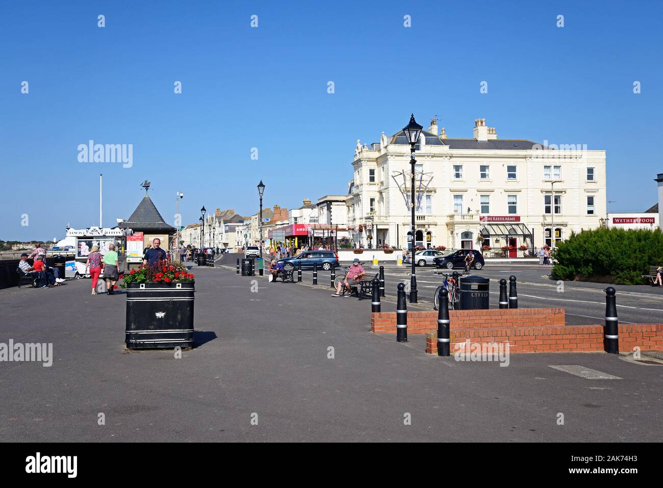 View along The Esplanade on the waterfront with tourists enjoying the setting, Burnham-on-Sea, England, UK. Stock Photo