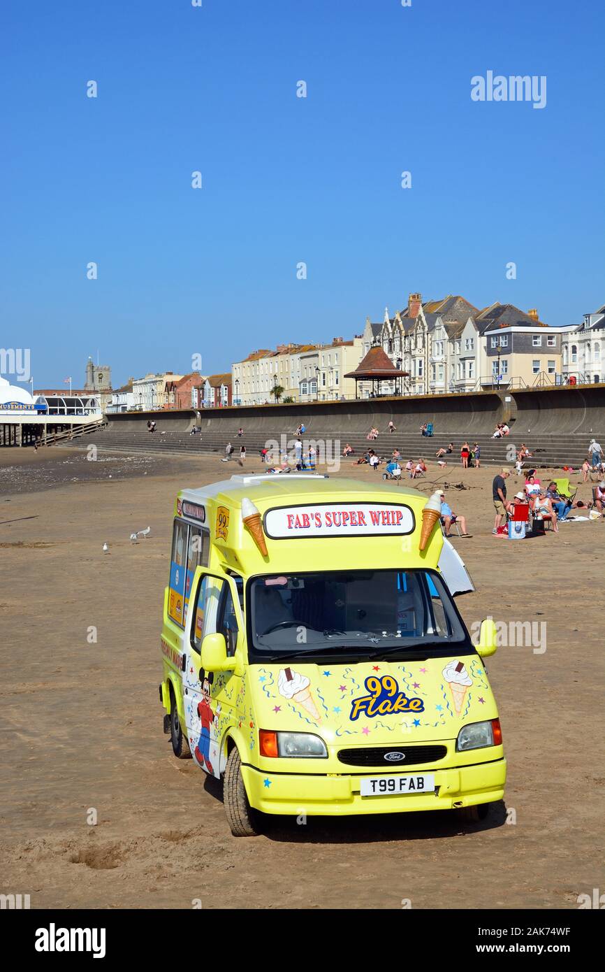 Tourists relaxing on the beach with an ice cream van in the foreground, Burnham-on-Sea, England, UK. Stock Photo